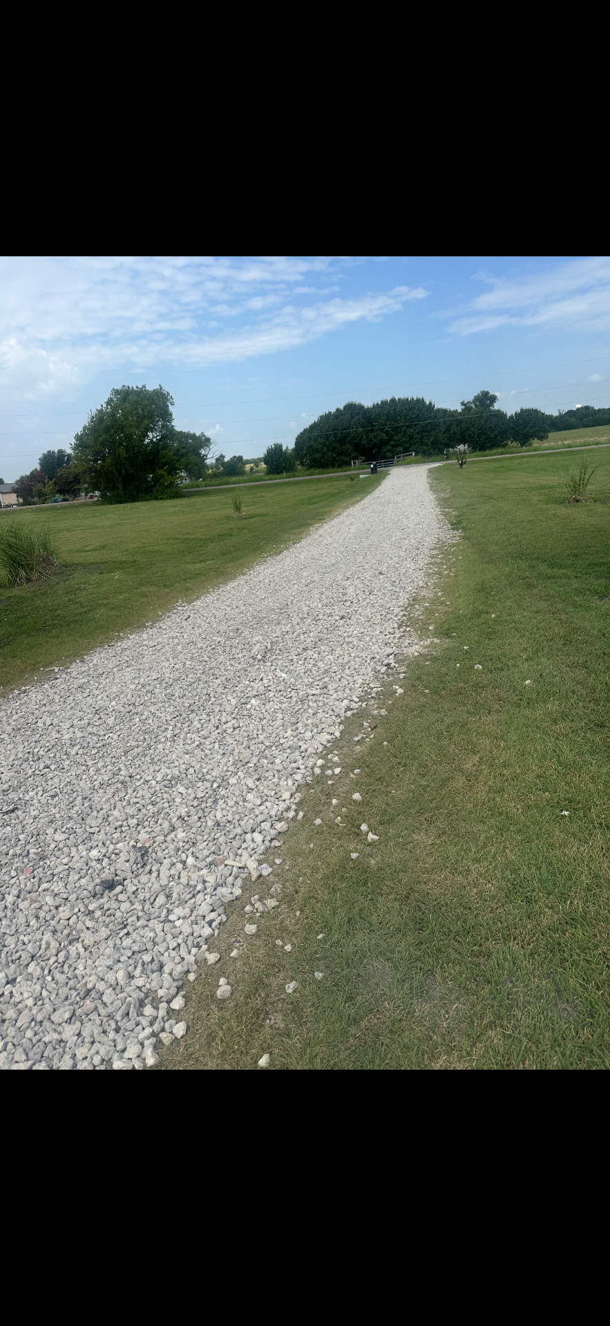 Finished gravel driveway after rocks were laid